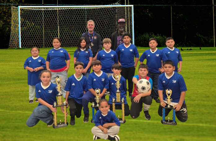  group of people kneeling and standing with throphies 